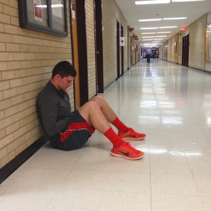 Austin Yeakey, junior student at Central Michigan, sits in Pearce hall with bright red shoes and red shorts. Photo by: Jermaine Fields